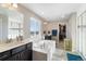Bright bathroom with dual vanities, soaking tub, and separate glass shower, perfect for relaxation at 1721 Wingfeather Ln, Castle Rock, CO 80108