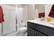 Bathroom featuring a modern shower with glass doors and dark wood vanity at 1721 Wingfeather Ln, Castle Rock, CO 80108