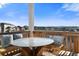 Outdoor deck with seating, table, and neighborhood views at 1721 Wingfeather Ln, Castle Rock, CO 80108