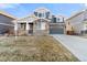 Two-story home featuring stone accents, a two-car garage, and a well-maintained lawn at 1721 Wingfeather Ln, Castle Rock, CO 80108