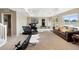 Spacious home gym with modern exercise equipment, plush carpet, and natural light at 1721 Wingfeather Ln, Castle Rock, CO 80108