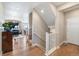 Welcoming foyer showcasing hardwood floors and open staircase at 1721 Wingfeather Ln, Castle Rock, CO 80108