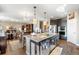 Modern kitchen with stainless steel appliances, granite countertops, island with bar seating, and hardwood floors at 1721 Wingfeather Ln, Castle Rock, CO 80108