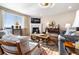 Inviting living room with a fireplace, large window, and stylish furnishings at 1721 Wingfeather Ln, Castle Rock, CO 80108