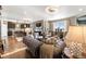 Open-concept living area with hardwood floors, kitchen island, elegant lighting, and comfortable seating arrangement at 1721 Wingfeather Ln, Castle Rock, CO 80108