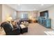 Comfortable living room with a large sectional sofa, accent furniture, and a wall-mounted television at 1721 Wingfeather Ln, Castle Rock, CO 80108