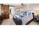Comfortable main bedroom features a wood-style barn door and plush bedding for a restful retreat at 1721 Wingfeather Ln, Castle Rock, CO 80108