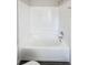 White bathtub with tiled surround in clean bathroom at 1335 S Danube Way # 105, Aurora, CO 80017