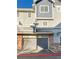 Attached garage with a gray door and brick exterior at 1335 S Danube Way # 105, Aurora, CO 80017