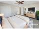 Main bedroom with a ceiling fan, large closets, and an en-suite bathroom at 1335 S Danube Way # 105, Aurora, CO 80017
