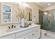Modern bathroom with double vanity, quartz countertop, and sleek glass-enclosed shower at 4588 S Versailles St # B, Aurora, CO 80015