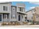 Modern townhouse with gray siding and stone accents, surrounded by landscaping at 4588 S Versailles St # B, Aurora, CO 80015