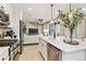 Modern kitchen with quartz counters and stainless steel appliances that opens to living area at 4588 S Versailles St # B, Aurora, CO 80015