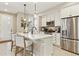Modern kitchen with white cabinets, quartz countertops, and stainless steel appliances at 4588 S Versailles St # B, Aurora, CO 80015