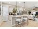Bright, open kitchen with white cabinets, center island, and stainless steel appliances at 4588 S Versailles St # B, Aurora, CO 80015