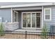 A gray home featuring a walk-out patio enclosed by a sleek black fence, inviting indoor-outdoor living at 4588 S Versailles St # B, Aurora, CO 80015