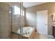 Bathroom featuring a glass shower, soaking tub, and tile accents with view of the doorway to a walk-in closet at 1017 Mircos St, Erie, CO 80516