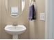 Bathroom sink with vanity mirror, a towel rack, and a light switch on the wall at 1017 Mircos St, Erie, CO 80516