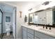 Modern bathroom featuring a double vanity, framed mirror, and stand up shower at 1017 Mircos St, Erie, CO 80516