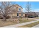 Charming two-story home with well-maintained landscaping, a neat lawn, and mature trees at 1017 Mircos St, Erie, CO 80516