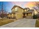 Lovely two-story home with stone accents, covered porch, and well-manicured landscaping at 1017 Mircos St, Erie, CO 80516