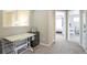 Hallway featuring neutral carpet, desk, storage, and views into the bedroom at 1017 Mircos St, Erie, CO 80516