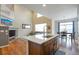 Bright open-concept featuring an island sink, modern kitchen, and natural light at 1017 Mircos St, Erie, CO 80516