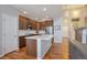 Modern kitchen features stainless steel appliances, quartz countertops, and a functional island at 1017 Mircos St, Erie, CO 80516