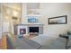 Spacious living room featuring a fireplace, high ceilings, and comfortable gray sectional sofa with stylish decor at 1017 Mircos St, Erie, CO 80516