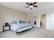 Main bedroom with a comfortable king bed and large windows, plus a doorway with hallway and stairs at 1017 Mircos St, Erie, CO 80516