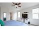 Stylish main bedroom with mountain decor above the television, plus a doorway into a bathroom at 1017 Mircos St, Erie, CO 80516