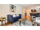 Open-concept living room with a blue sofa, stylish decor, and hardwood floors at 6168 Carr St, Arvada, CO 80004