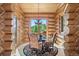 Charming log cabin dining room with elegant chandelier and forest view at 8699 Blue Creek Rd, Evergreen, CO 80439