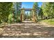 Welcome to Blue Creek Ranch through this gated entrance adorned with carved elk statues at 8699 Blue Creek Rd, Evergreen, CO 80439