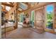 Grand log home foyer with stone floors, wooden accents, and abundant natural light, creating a warm and inviting entryway at 8699 Blue Creek Rd, Evergreen, CO 80439
