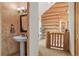 Charming hallway with powder room and rustic wood accents, showcasing log cabin design at 8699 Blue Creek Rd, Evergreen, CO 80439