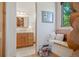 Hallway with bathroom view, features window seat and wooden accents showcasing log home architecture at 8699 Blue Creek Rd, Evergreen, CO 80439