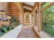 Inviting hallway with stone flooring and views of the surrounding greenery at 8699 Blue Creek Rd, Evergreen, CO 80439