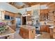 Beautiful kitchen with wooden beams, stainless steel appliances, and center island at 8699 Blue Creek Rd, Evergreen, CO 80439