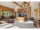 Office space in log cabin home features a large desk, custom cabinets, and exposed beams at 8699 Blue Creek Rd, Evergreen, CO 80439