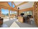 Spacious office area with natural light, a wood burning stove, and a walk-out patio at 8699 Blue Creek Rd, Evergreen, CO 80439