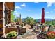 Mountain view from expansive outdoor patio with wicker furniture and seating at 8699 Blue Creek Rd, Evergreen, CO 80439