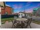 Backyard patio with seating, lawn, and colorful evening skies at 2815 Curtis St, Denver, CO 80205