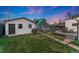 Backyard area featuring a lawn, stone paver path, a gray deck with furniture, and a shed at 2815 Curtis St, Denver, CO 80205