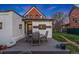 Backyard patio with table and seating, lawn, and red brick home at 2815 Curtis St, Denver, CO 80205