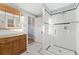 Well-lit bathroom featuring a tiled walk-in shower and dark wood vanity at 2815 Curtis St, Denver, CO 80205