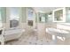 Bright bathroom featuring a claw foot tub, pedestal sink, and plenty of natural light from the windows at 2815 Curtis St, Denver, CO 80205