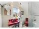 Unique bathroom featuring a red sink and toilet, and a glass enclosed shower at 2815 Curtis St, Denver, CO 80205