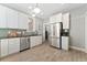 Kitchen features stainless steel refrigerator, dishwasher, and light wood flooring at 2815 Curtis St, Denver, CO 80205
