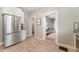 Open kitchen view showing stainless steel fridge and entrances to other rooms at 2815 Curtis St, Denver, CO 80205